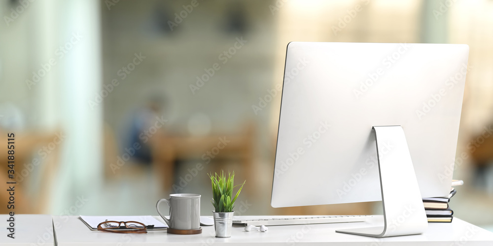 Wall mural workspace computer monitor putting on white working desk and surrounded by wireless keyboard, stack 