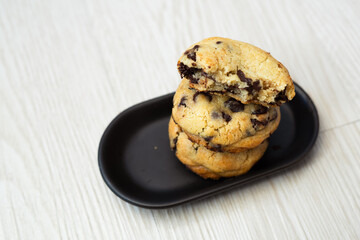 Soft and chewy chocolate chip cookies on a wooden table