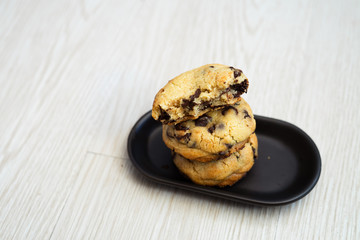Soft and chewy chocolate chip cookies on a wooden table