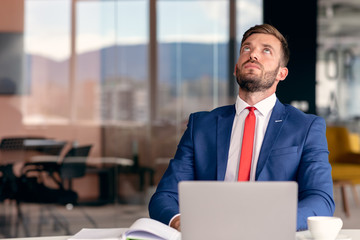 Portrait of worried young man at workplace. Stress concept