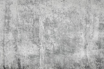 Gray concrete surface with cracks. An image of a cemented surface with a grunge, dirty stain, as an idea for making a background.