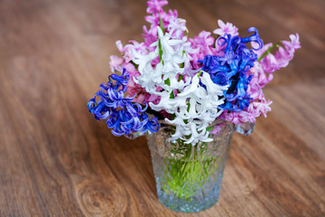 Hyacinth Flowers in a Glass Vintage Vase on a Wooden Background