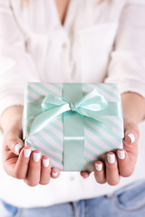 human hands holding a gift