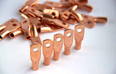 Copper electric terminals. connection tips for cables and wires. electrician accessories and spare parts. reliable contact. energy industry and electrical safety concept. copy space.