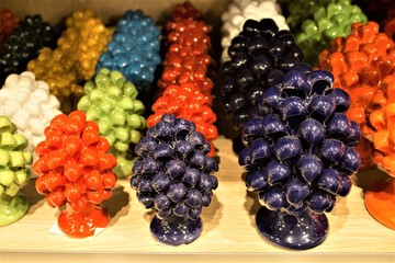 various colored porcelain pine cones typical of artisan production Sicilian to promote the Sicily region in Italy