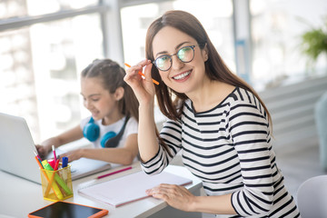 Mom and daughter at home go about their business.