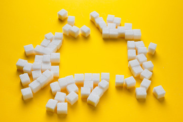 Refined sugar cubes shot on a yellow background. Background for sweets, food and drinks.