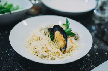 Cooking pasta with seafood in a cooking class. Italian pasta with seafood. Mussels
