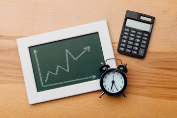 charts of economics and stock markets on a chalk board. financial crisis concept.