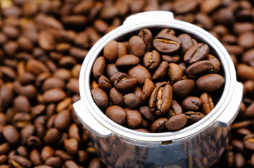 Scoop of roasted coffee beans, can be used as a background
