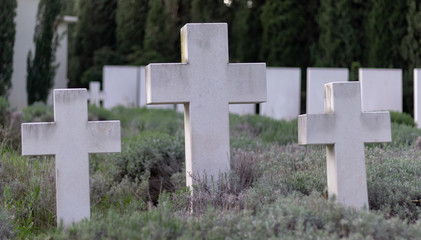 One big cross and two smallers ones marking an unknown grave to fallen german world war two soldiers. Public graveyard in Split, Croatia