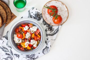 Healthy salad with grilled pepper, tomatoes, stracciatella, herbs and pumpkin seeds. Healthy eating concept.