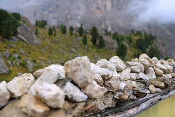 Piles stones folded neatly by tourist in summer on foggy day. Relax. Tourist crossing in mountains.