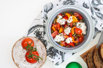 Healthy salad with grilled pepper, tomatoes, stracciatella, herbs and pumpkin seeds. Healthy eating concept.