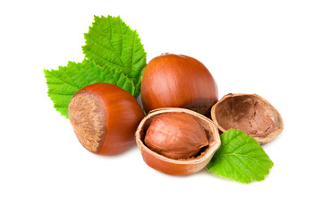 hazelnuts with green leaf isolated on white background