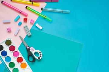 School supplies, stationery on yellow background - space for caption. Child ready to draw with pencils and make application of colored paper. Top view.