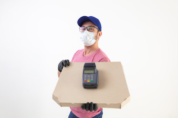 Delivery guy with protective mask holding pizza box and POS for contactless payment.