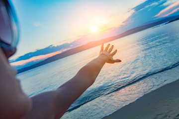 Silhouette of a girl enjoying at ocean / sea shore in sunset time.