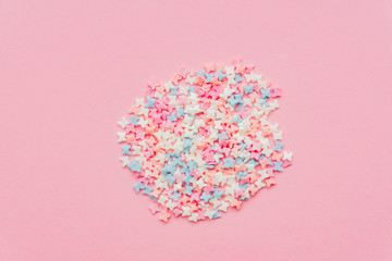 Sprinkle circle shape background. Sprinkle in the form of butterfly on pink background. copy space. top view