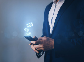 Businessman hand using mobile smartphone with message icon. Email, communication concept.