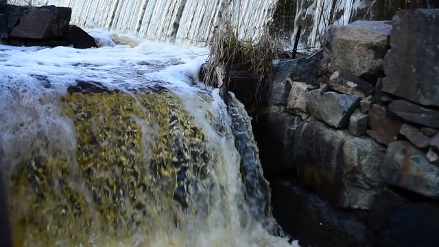 Running water from an old mill where the water flows in sections down to a small river located in Forsmark Sweden.