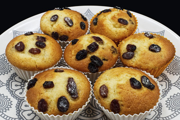 Freshly baked delicious muffins on a colored dish