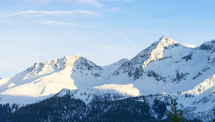 Closeup of snow-capped mountain peaks in winter, morning sunlight, Switzerland, copy space