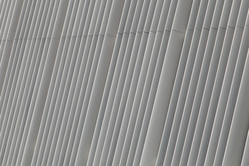 Silver-gray parallel metal striped lines with natural light.
