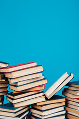 a lot of stacks of educational books in the college library on a blue background
