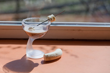 white creamy milkshake with banana in a glass.Baileys