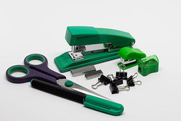Staplers with staples, binder clips, scissors, pencil sharpener, permanent marker isolated on white...