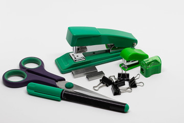 Staplers with staples, binder clips, scissors, pencil sharpener, permanent marker isolated on white...