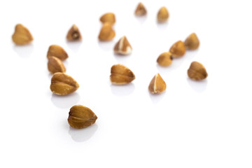 Buckwheat isolated on white. Brown organic vegetarian cereal seeds. Raw grains food. Vegan gluten-free organic, healthy diet superfood with antioxidant, omega-3, protein, mineral nutrients.