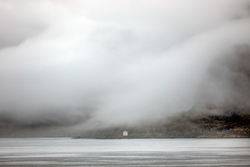 Little house isolated in the mist