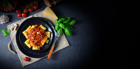 Rigatoni pasta with Bolognese sauce and fresh basil