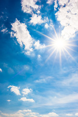 Beautiful, blue summer sky with fluffy clouds and bright sun as a background - 341913549