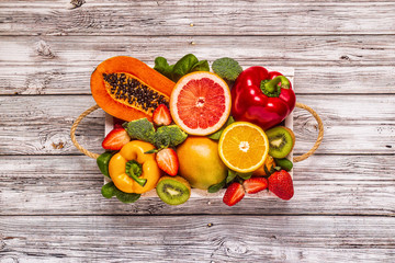 Fruits and vegetables rich in vitamin C in box. Healthy eating.