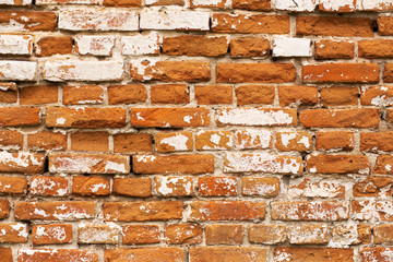 Old crumbling red brick wall. Texture, close-up.