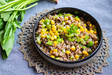 Buckwheat grain porridge with sweet corn and parsley herbs. Russian traditional vegan food. Table.