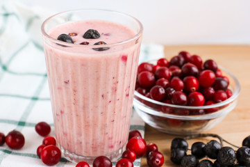 Healthy natural fresh smoothie with cranberries in a glass. Selective focus, copy space, close up. Concept of superfood.