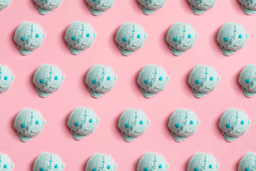 Seamless pattern of balls of natural blue ice cream on a pink background
