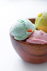 Bowl with fresh natural colorful ice-cream macro background.