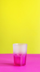 Isolated transparent empty drinking colored glass on colorful background minimalist copy space mockup