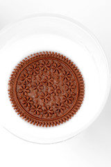 chocolate cookies with cream in a glass of milk