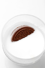 chocolate cookies with cream in a glass of milk