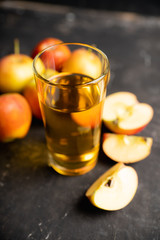 Apple juice with freshly harvested apples on the rustic background. Selective focus. Shallow depth of field.
