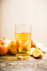 Apple juice with freshly harvested apples on the rustic background. Selective focus. Shallow depth of field.