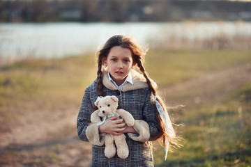 young woman with a dog. young woman with a teddy bear. young woman walking in the park