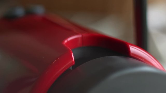 Organic compostable espresso pods. Amazing slow-motion closeup of inserting a coffee capsule in an automated espresso coffee machine. Morning breakfast, Closeup of woman's hand. Red coffee maker.