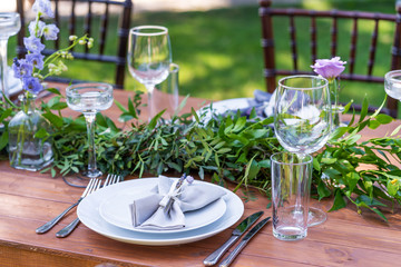 Preparing for an open-air party. Decorated with fresh flowers served tables. Table number. Decoration Details
